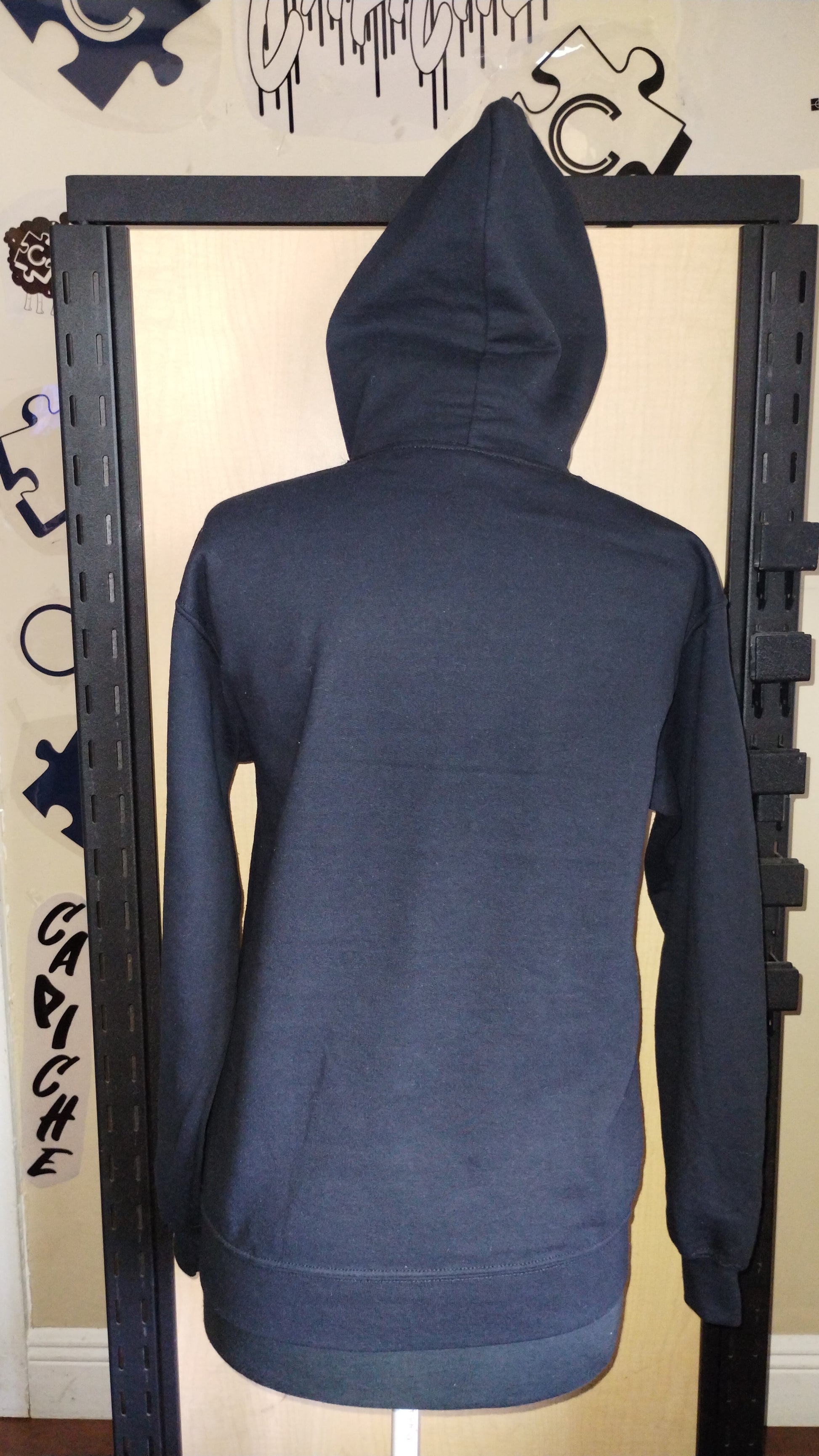 Back view of black hoodie on manikin.