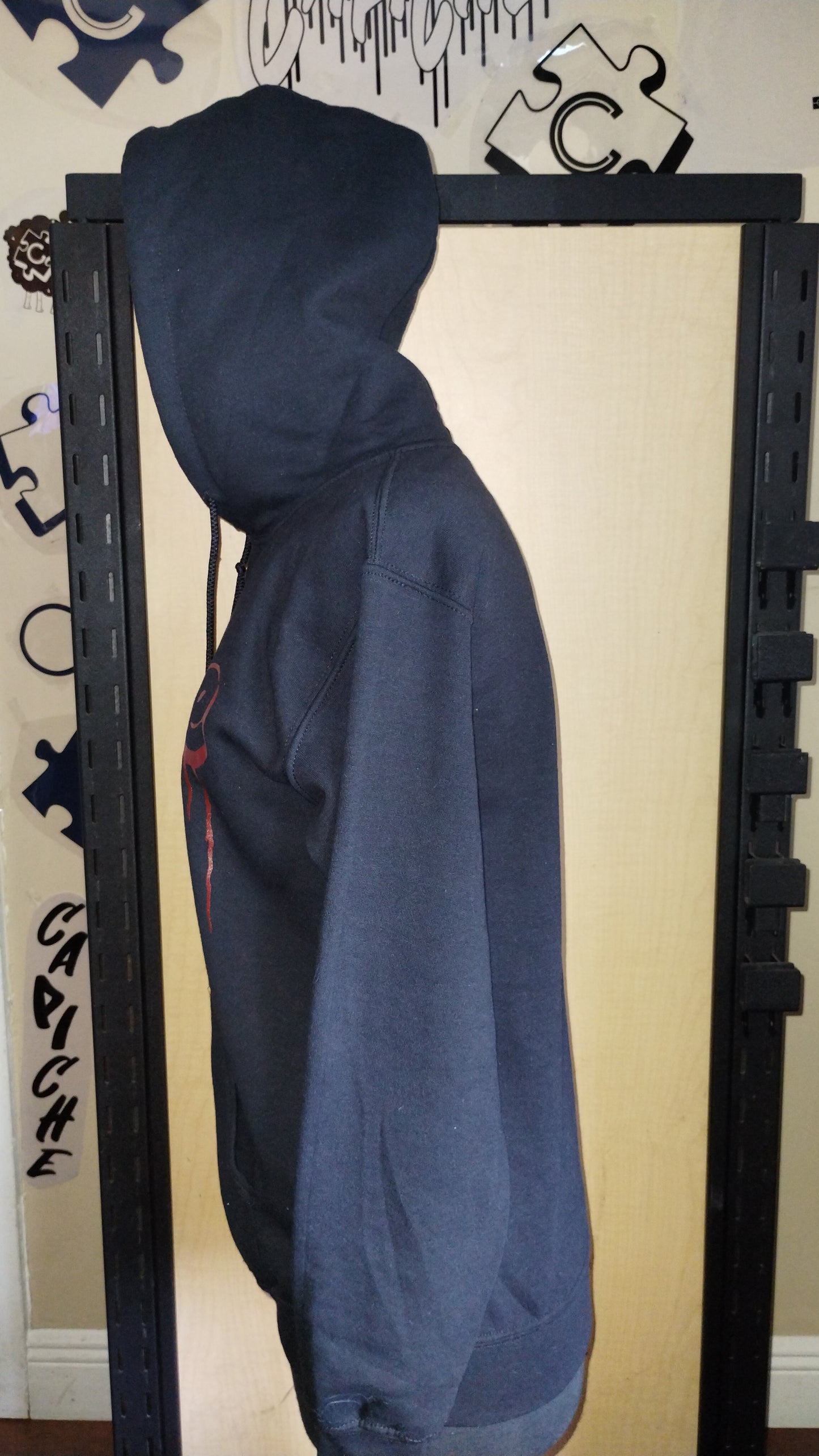 Side view of black hoodie on manikin.