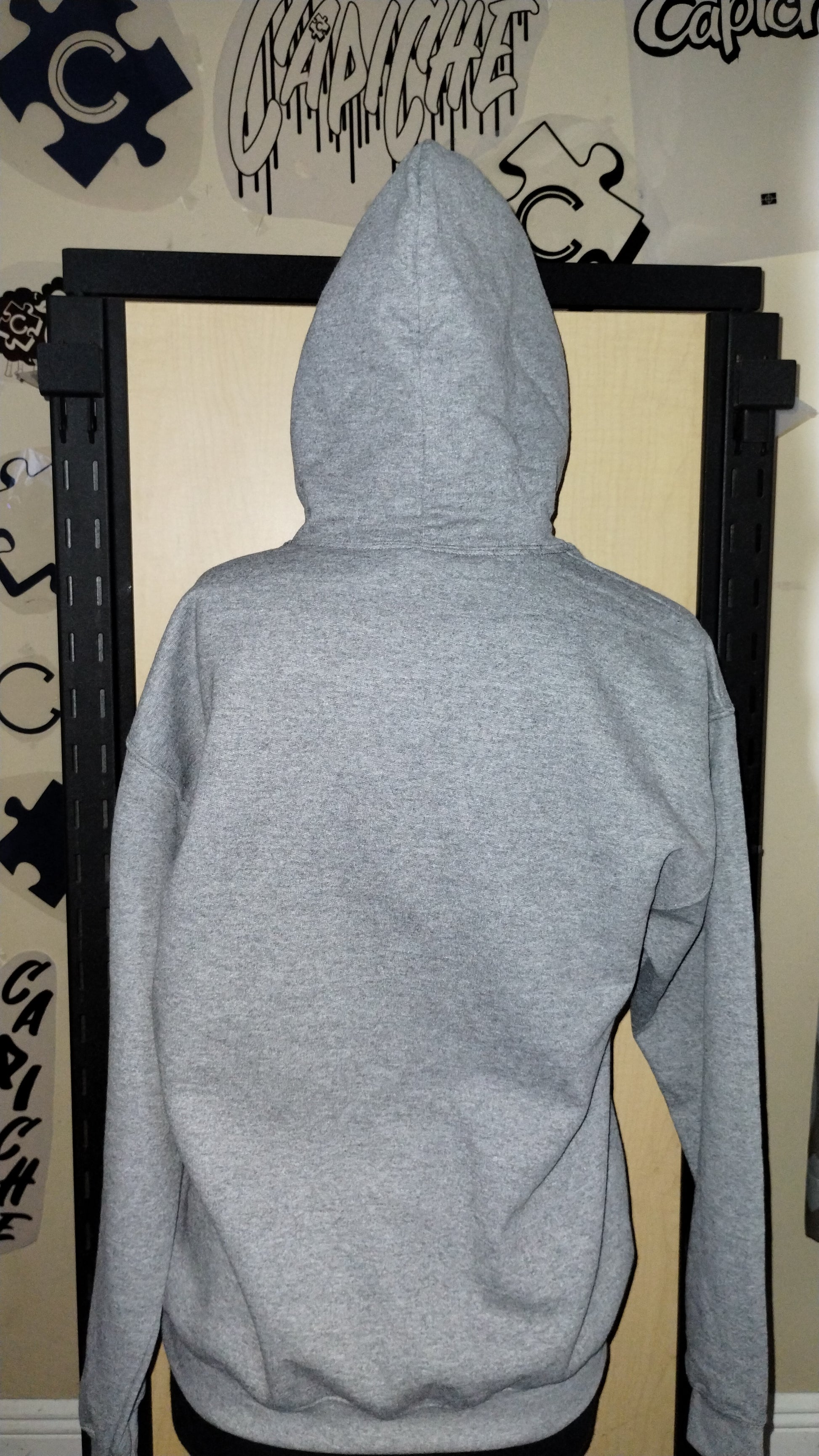 Back of grey hoodie on a manikin.