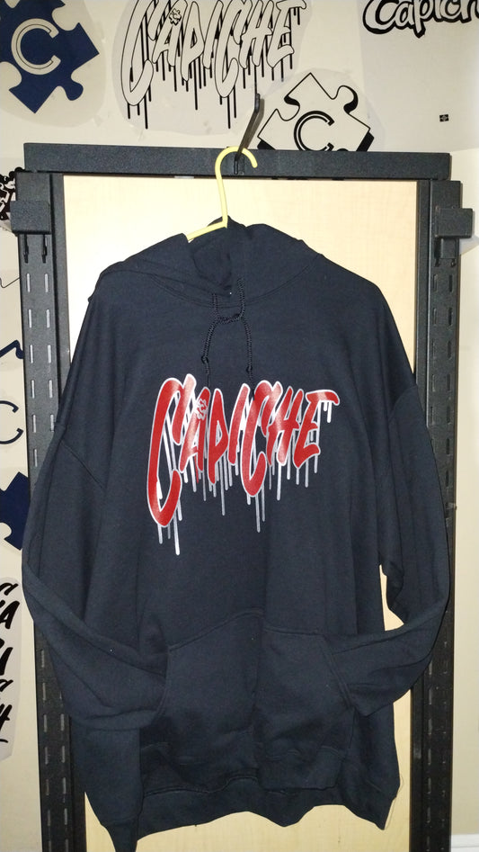 Front View of Black Hoodie on a hanger. Capiche logo printed in red and liquid silver ink.