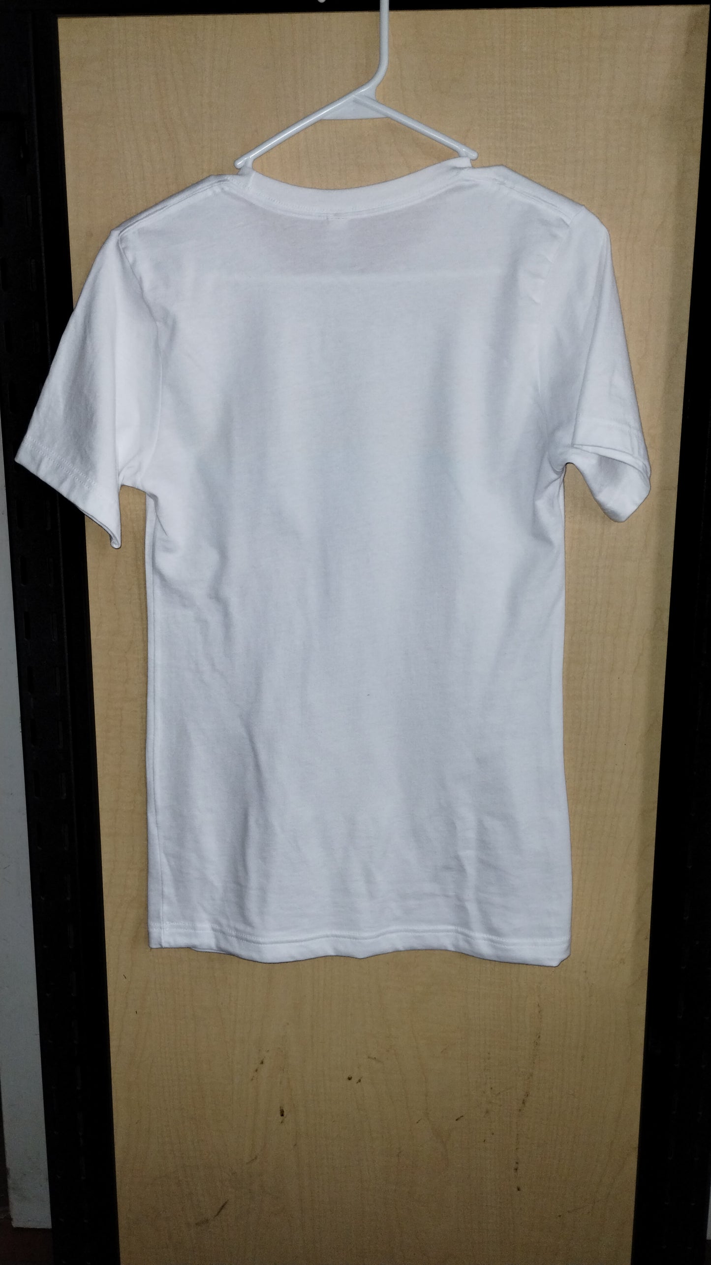 Rear view of white shirt on hanger